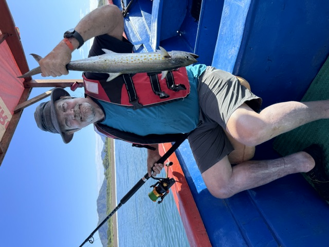 Guest holding a mackerel on a Costa Rica fishing tour