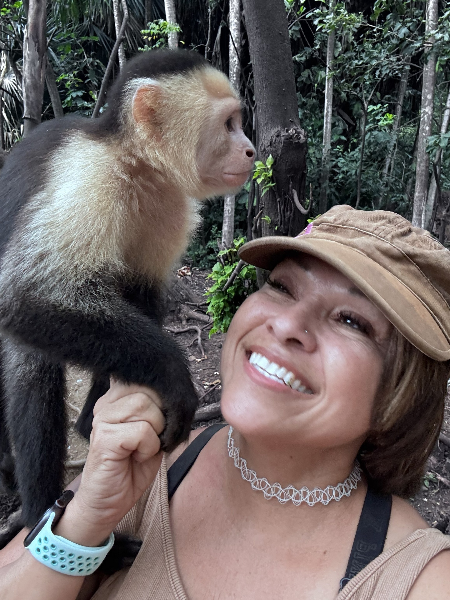 Scheyla smiling with a capuchin monkey on her shoulder